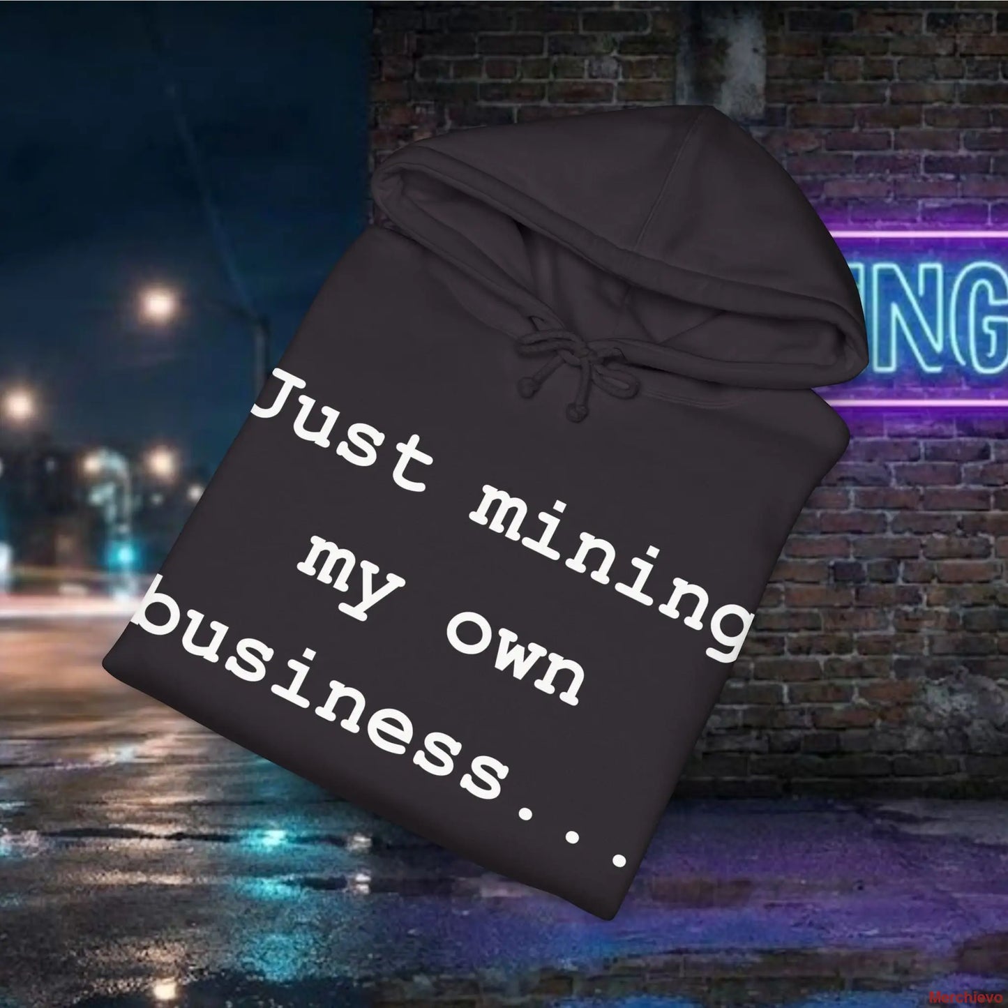 Black hoodie with text 'Just mining my own business...' against a nighttime city street background.