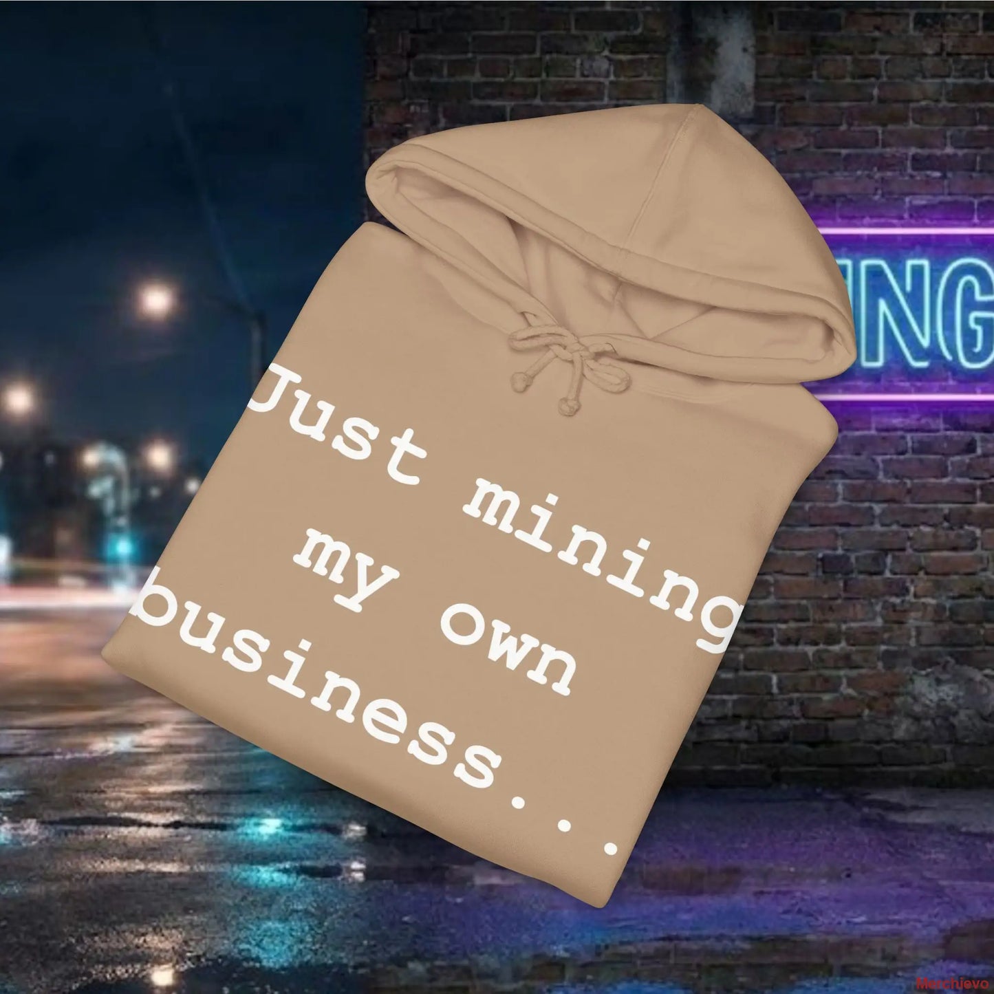 Beige hoodie with text 'Just mining my own business...' against a nighttime city street background.