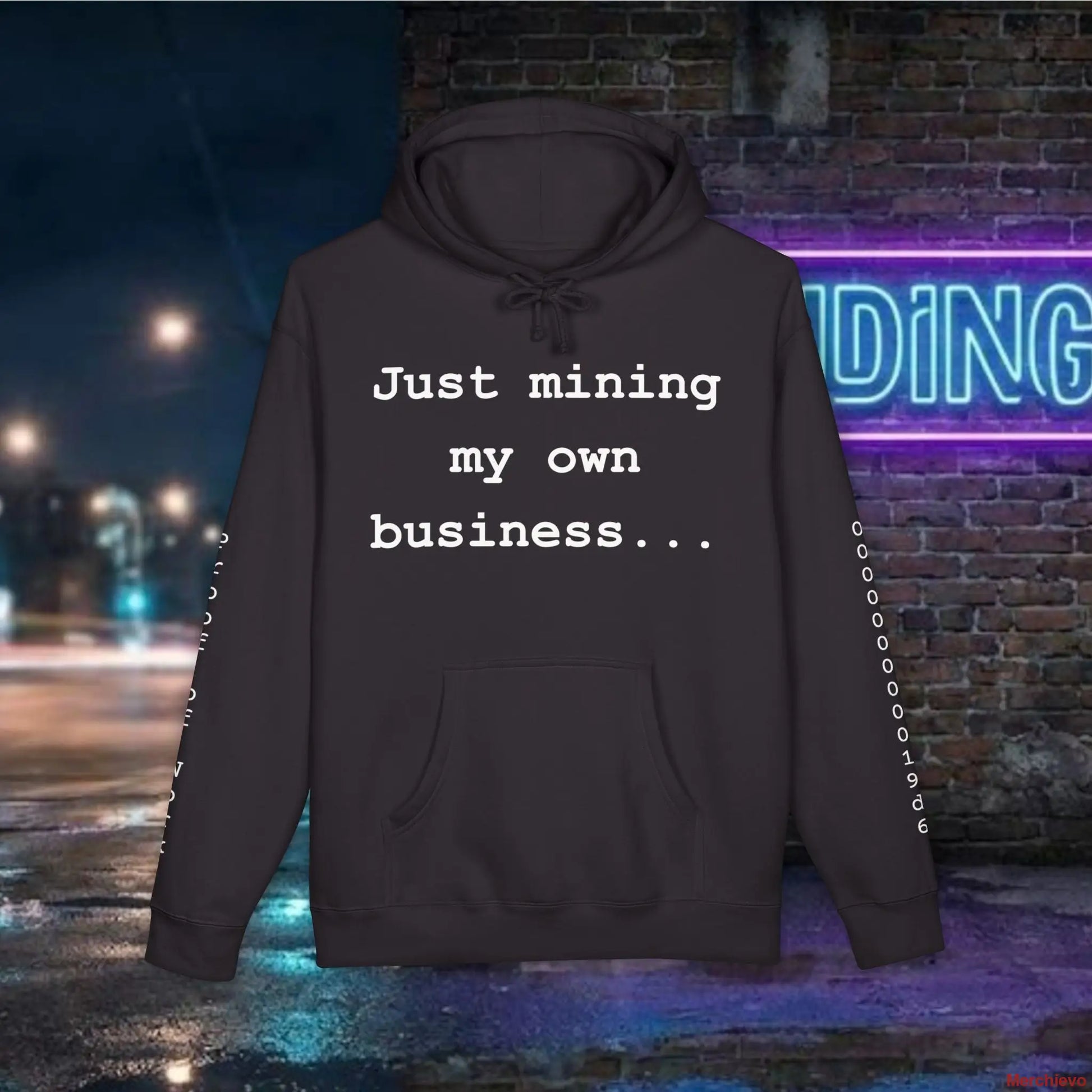 Minimalist white text reading "Just mining my own business..." centered on the chest of a premium black heavyweight hoodie.