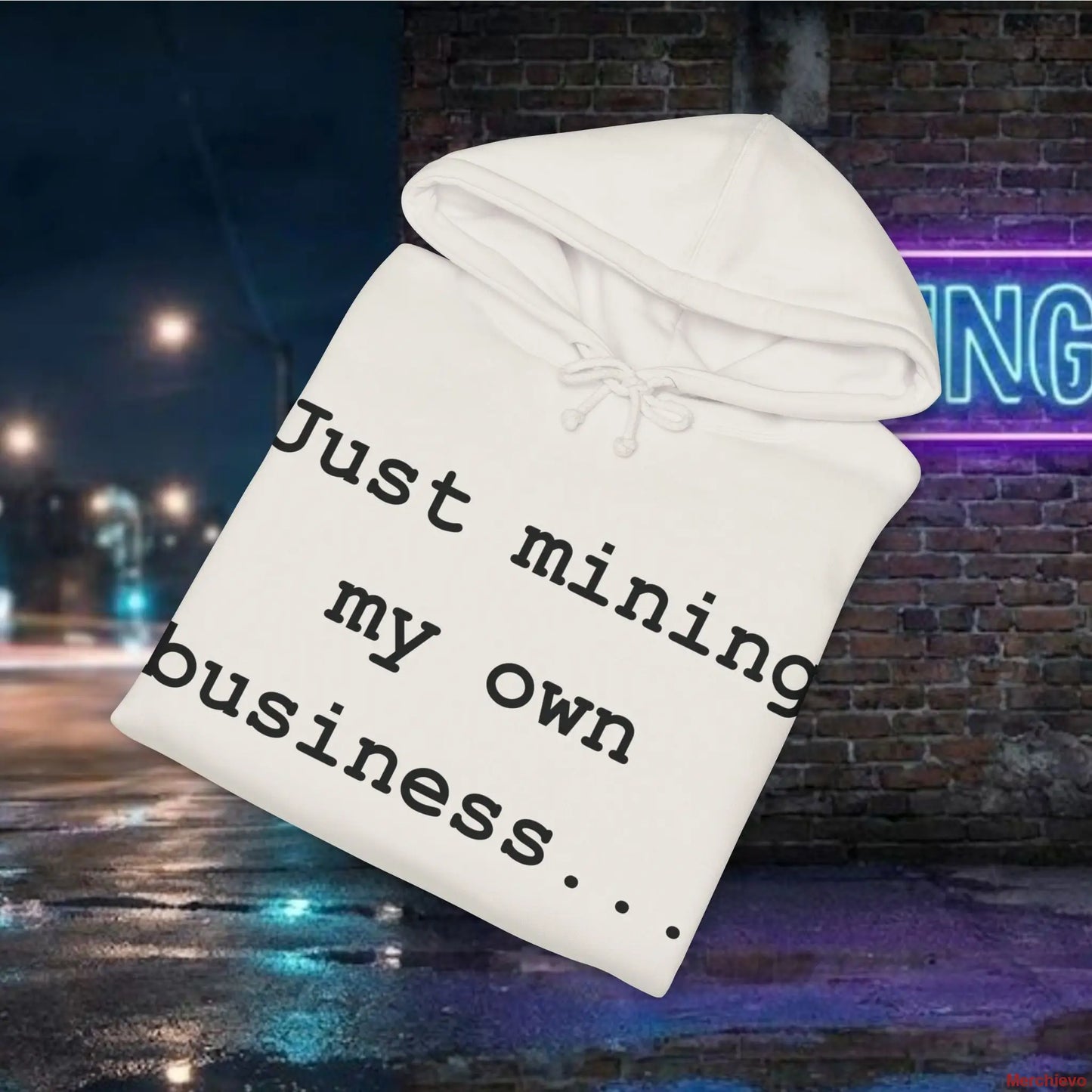 White hoodie with text 'Just mining my own business...' against a nighttime city street background.