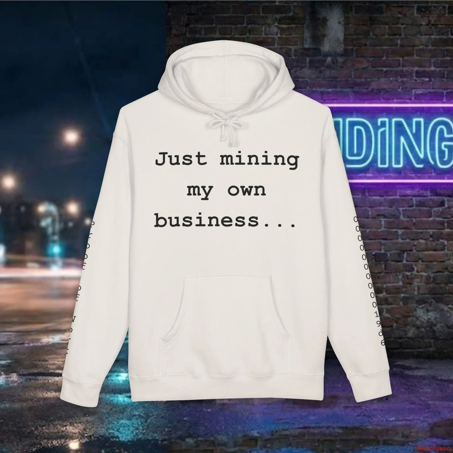 White hoodie with text 'Just mining my own business...' against a nighttime city street background.