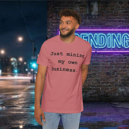  Minimalist "Just mining my own business" text in a modern sans-serif font centered on a white premium cotton jersey t-shirt. 